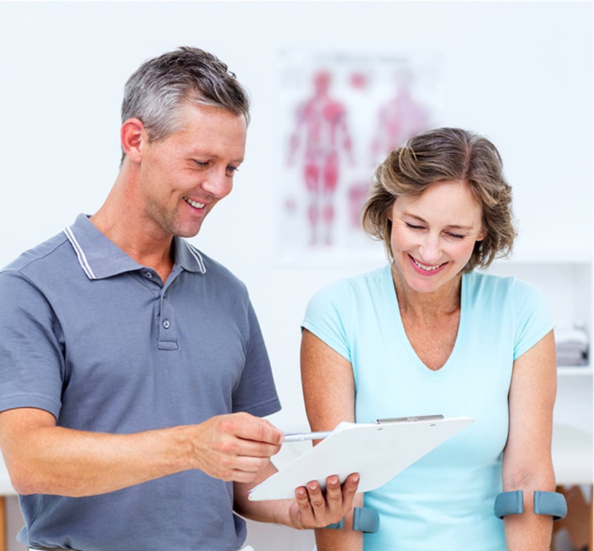 A patient being welcomed at the front desk of a Peak Injury Clinics location