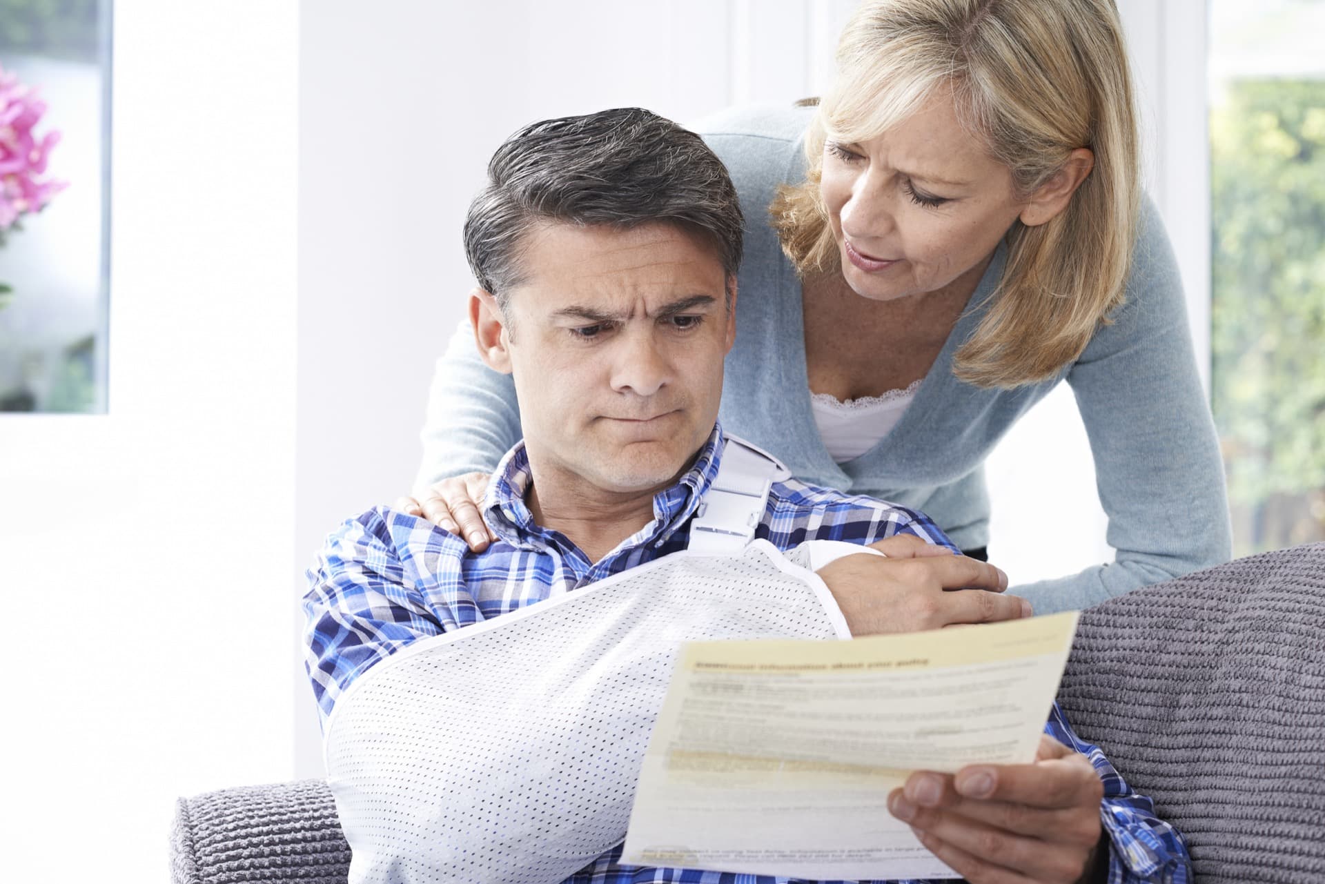 A provider examining a patient's shoulder at a Peak Injury Clinics location